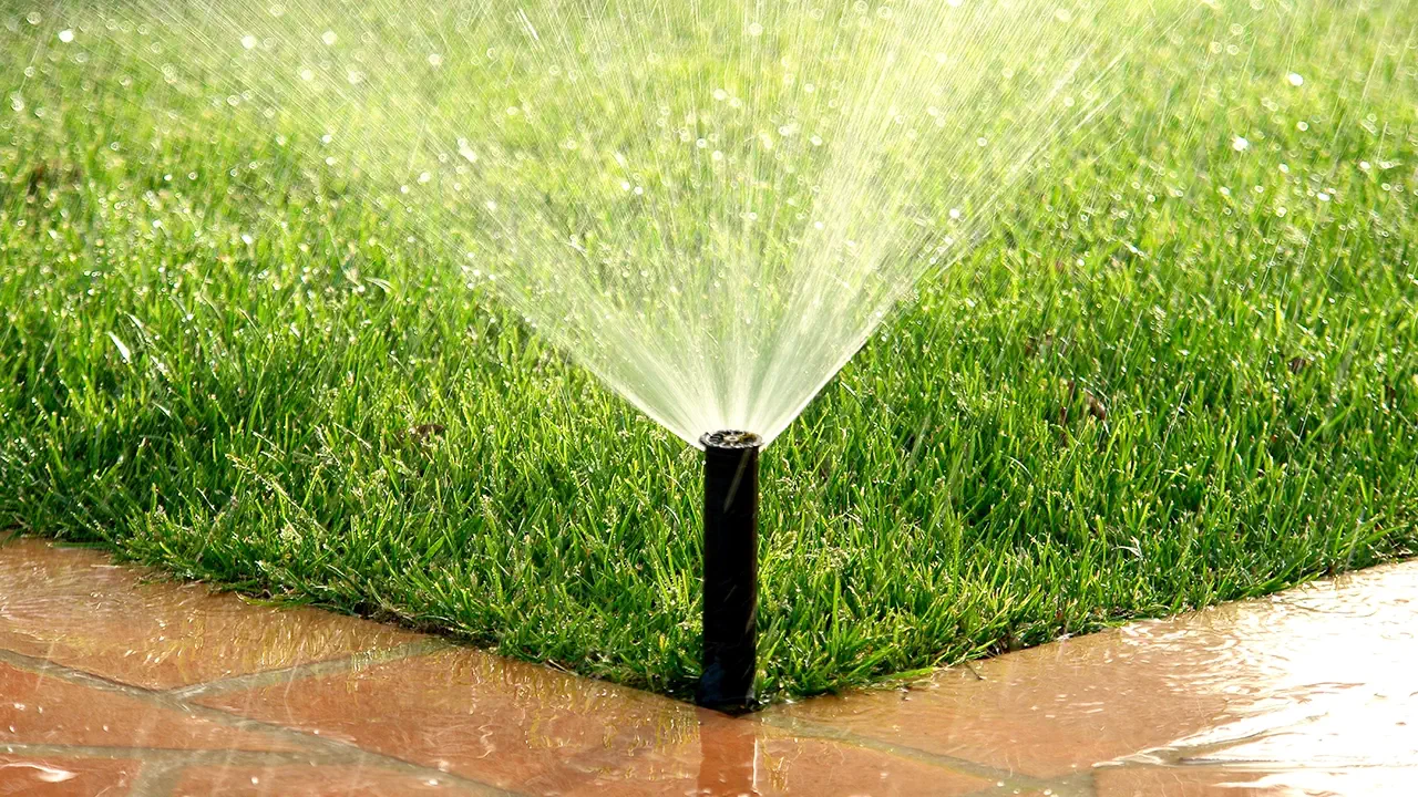 A water nozzle is watering the lawn.